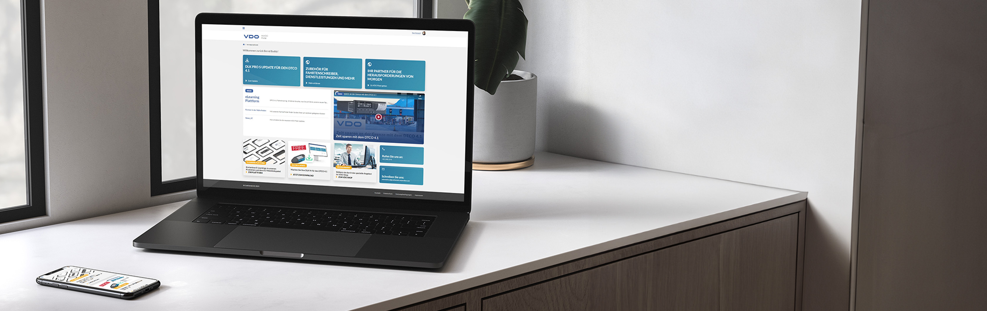 The image shows a laptop and a smartphone on a white windowsill, each with the home screen of the My VDO application. The application is the ideal point of contact for all fleet operators looking for guides, e-learning and up-to-date information. )